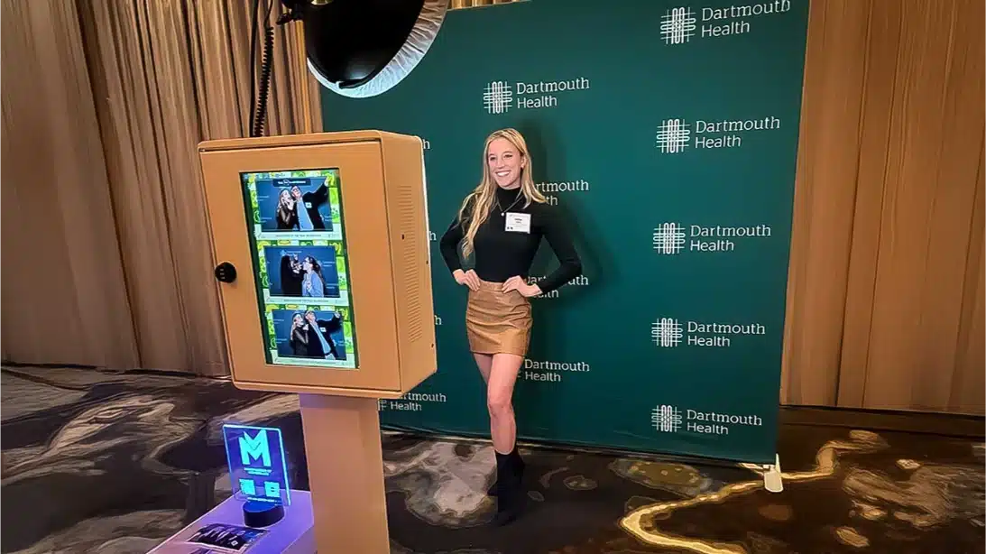 corporate photo booth rental. Business professionals taking group photos at a corporate holiday party booth