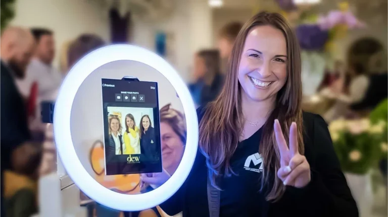 About Us – Magic Mirror of New England. new england photo booth rental. a photo booth attendant using a photo booth at a corporate event