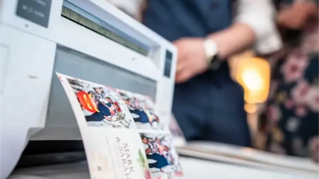 High-quality photo printer producing printed keepsakes from a photo booth, showcasing vibrant images with customizable designs for events and celebrations.