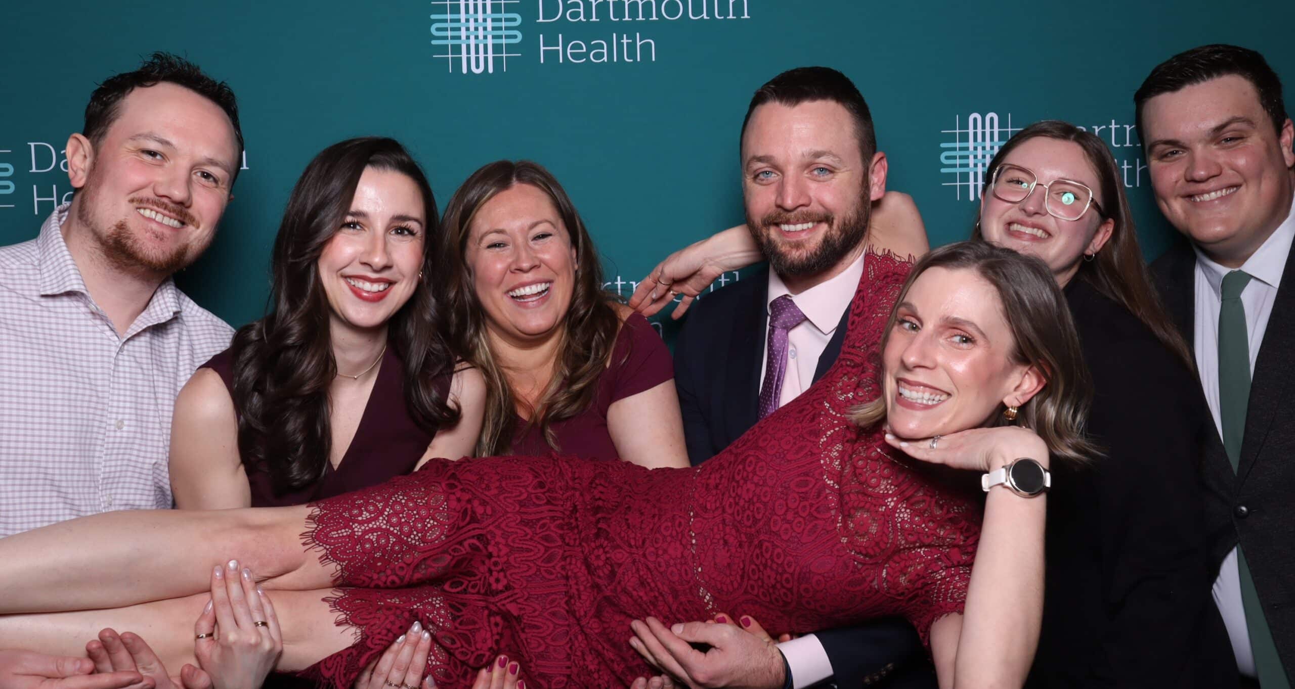 Guests posing at a Glam Photo Booth with branded Dartmouth Health backdrop at the Citizen of the Year 2026 Gala in Manchester NH