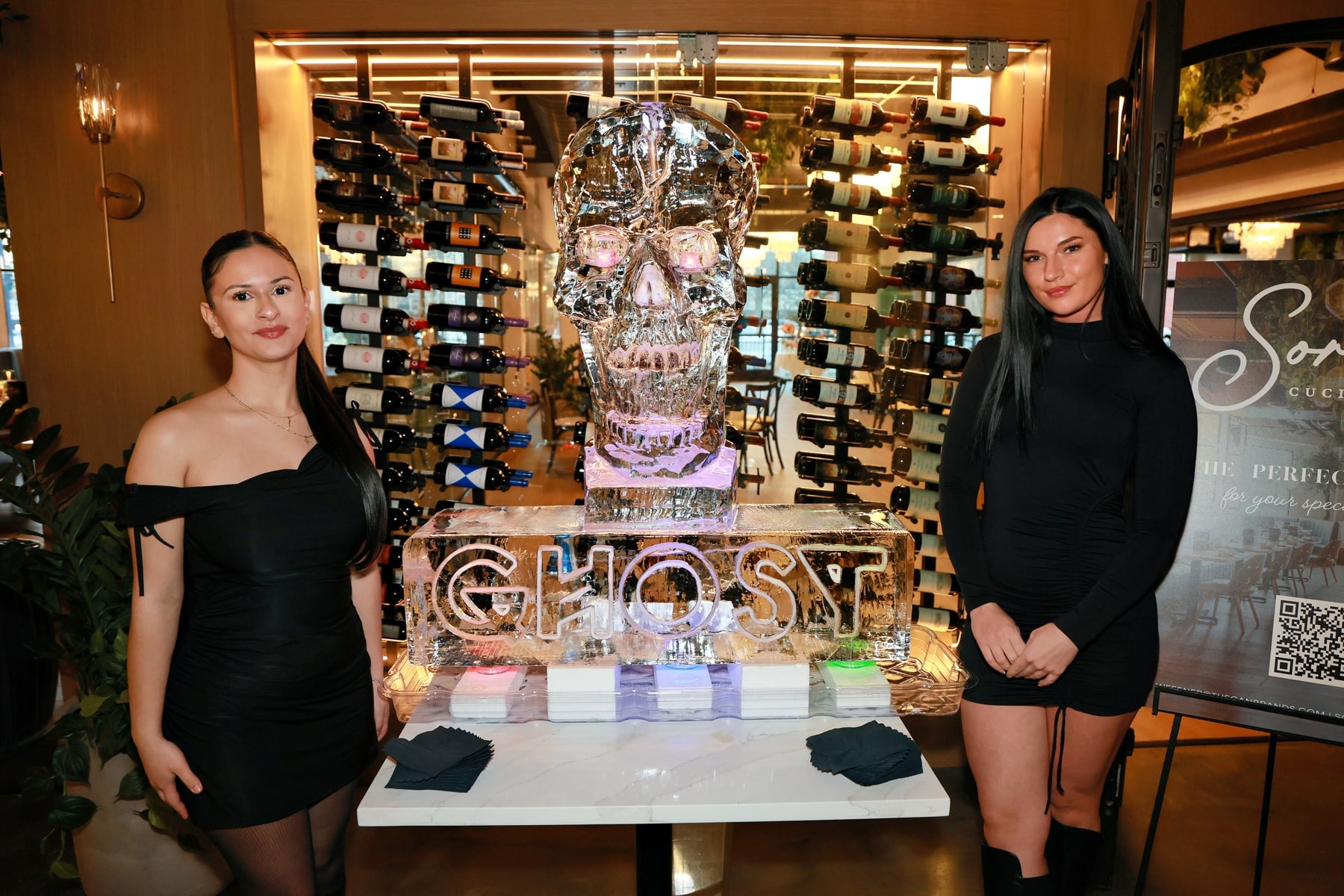 Two girls posing in front of Ghost Tequila ice luge at Sorella Burlington grand opening with event photography and instant delivery