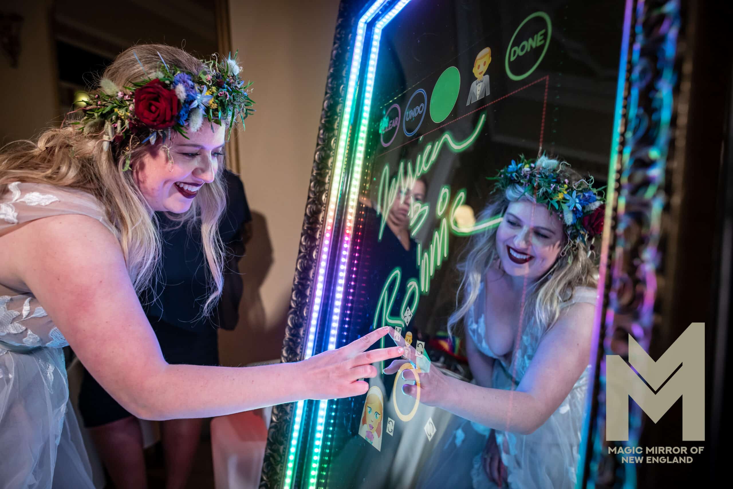A lovely bride putting finishing touches to the photo preview she had taken on the Mirror me by using the signing feature