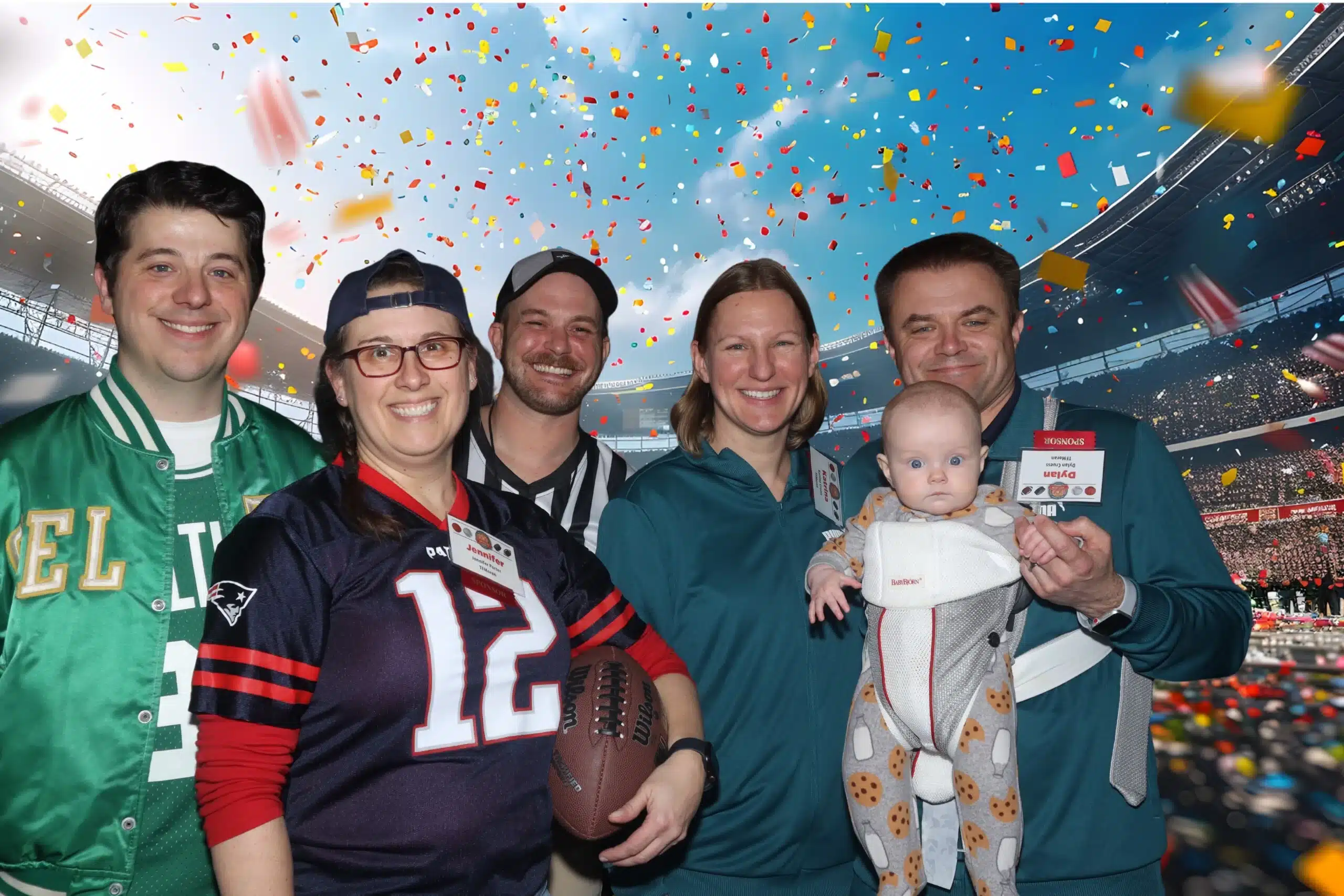 Group of attendees in sports-themed attire, celebrating at the Best of Business Awards 2025, with confetti and a football stadium backdrop, featuring a baby in a carrier and props for interactive photo booth experience.