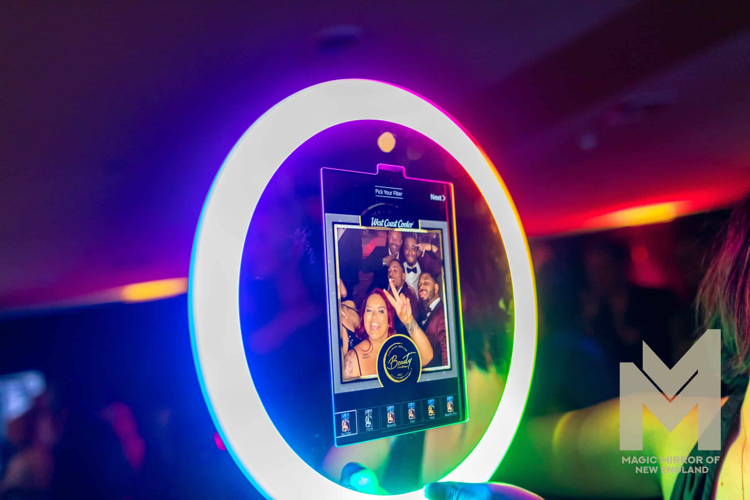 Roaming photo booth attendant capturing candid guest photos and interactive moments during cocktail hour at a wedding reception.