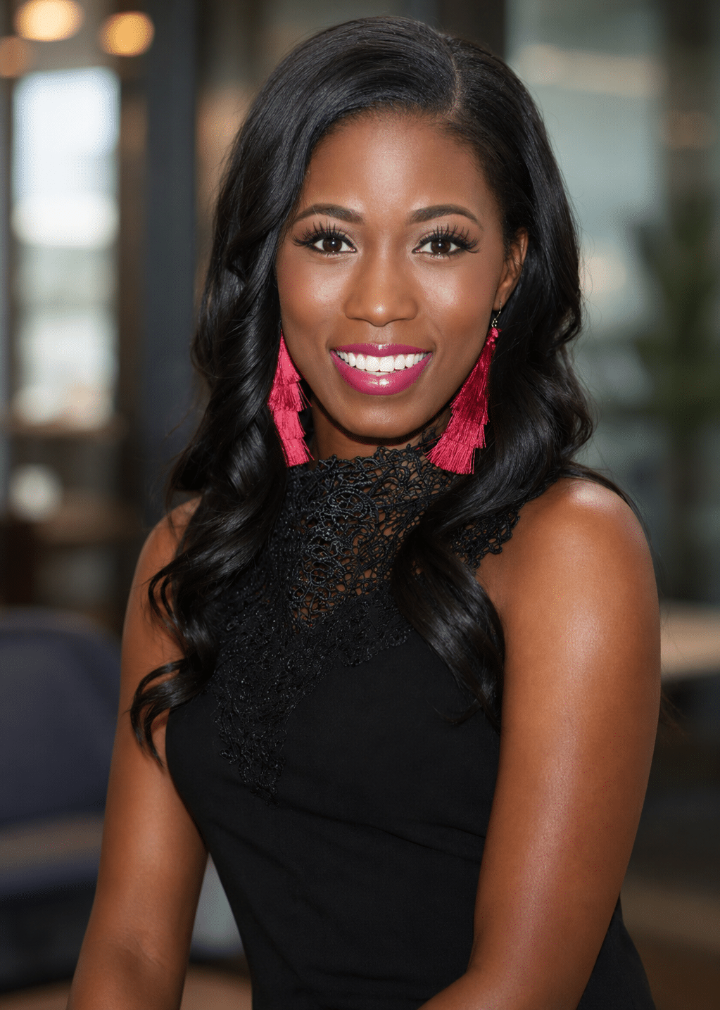 AI-generated headshot portrait of a woman in a black lace dress with pink tassel earrings, showcasing professional photography for event experiences.