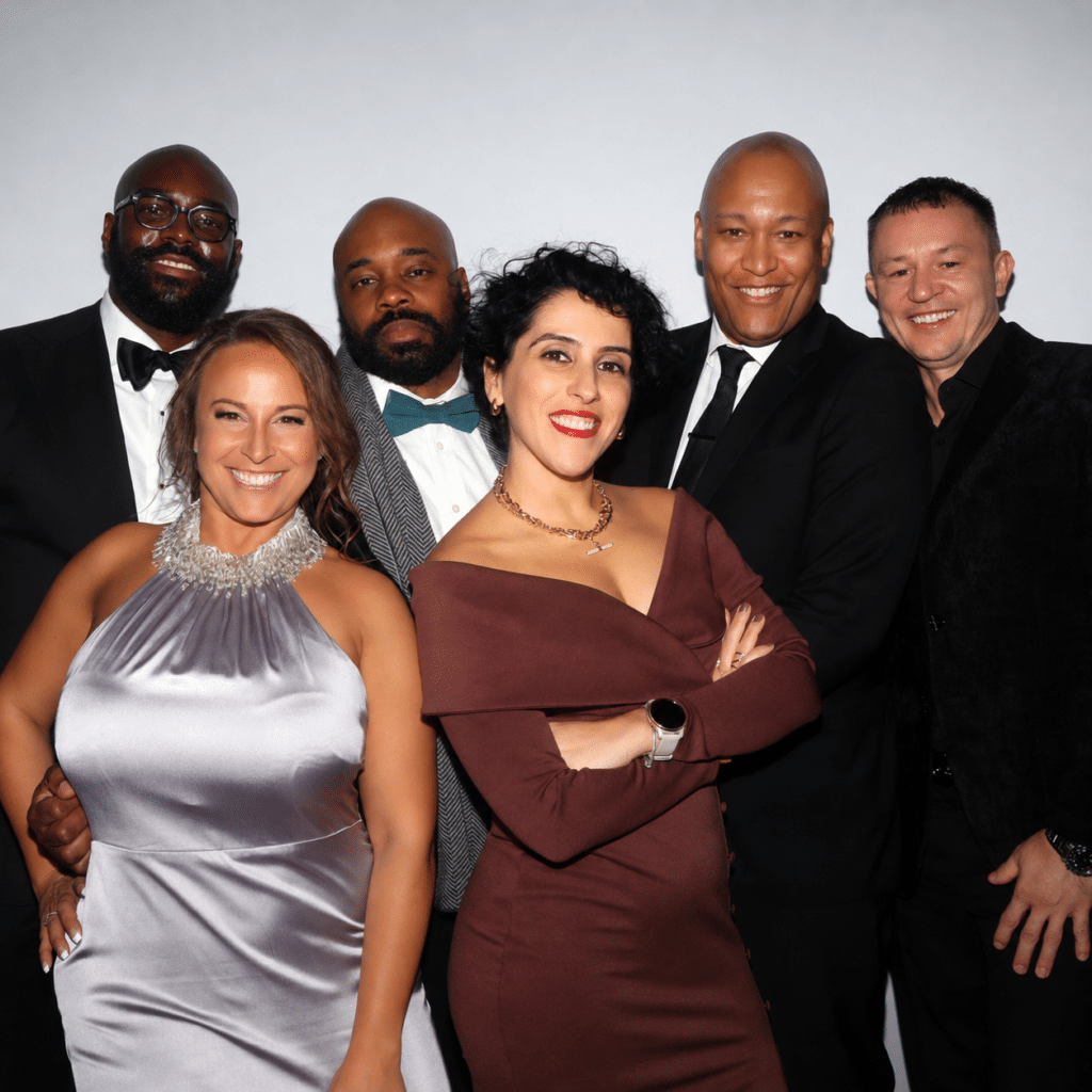 Group of six guests posing together in formal attire at Boston’s Runway Ball photo booth event.