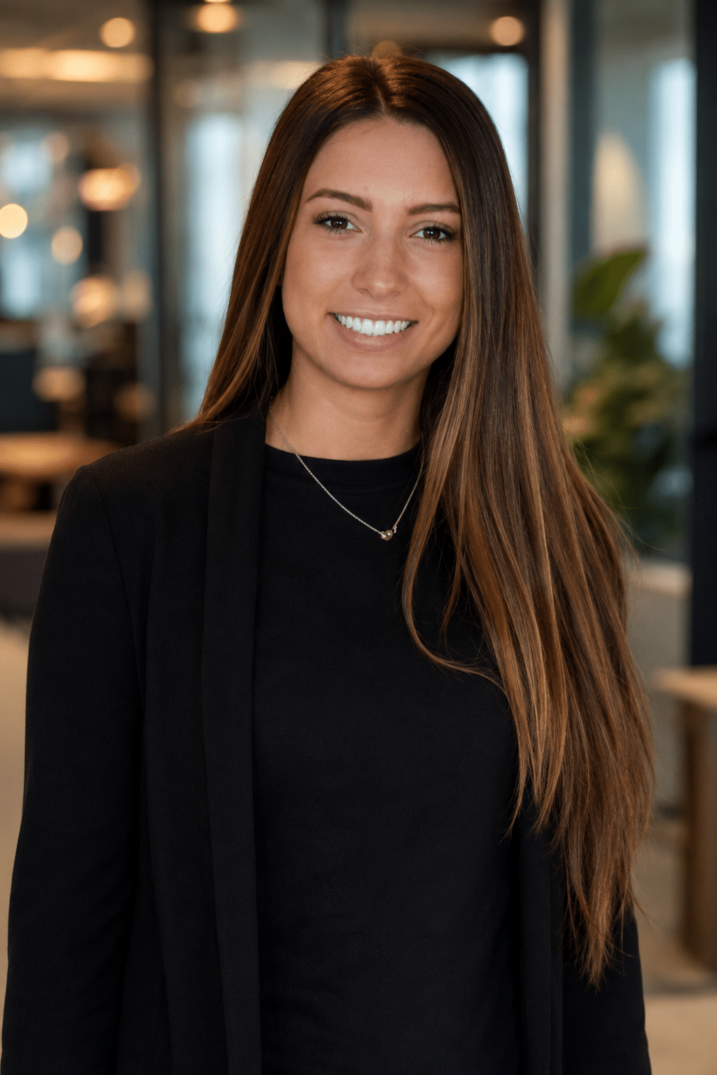 AI-generated headshot of a woman with long hair, wearing a black top and jacket, in a modern indoor setting, highlighting studio-quality photography for event experiences.