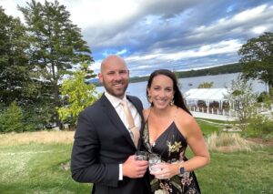 A couple taking a photo in front of an outdoor wedding