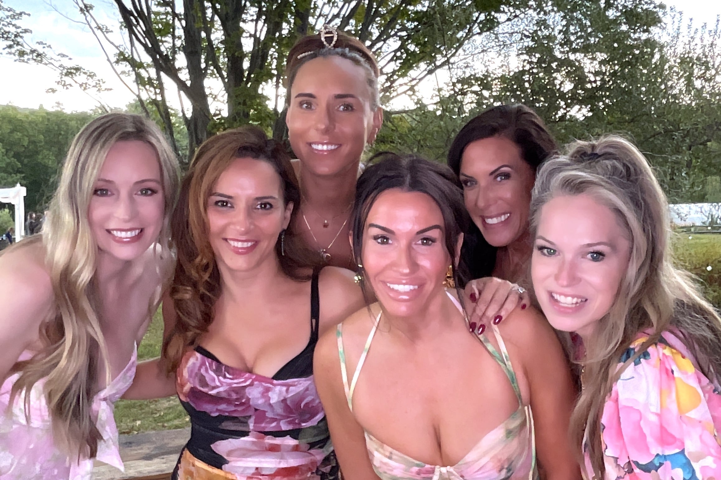 Group of smiling women enjoying a photo booth experience at an event.