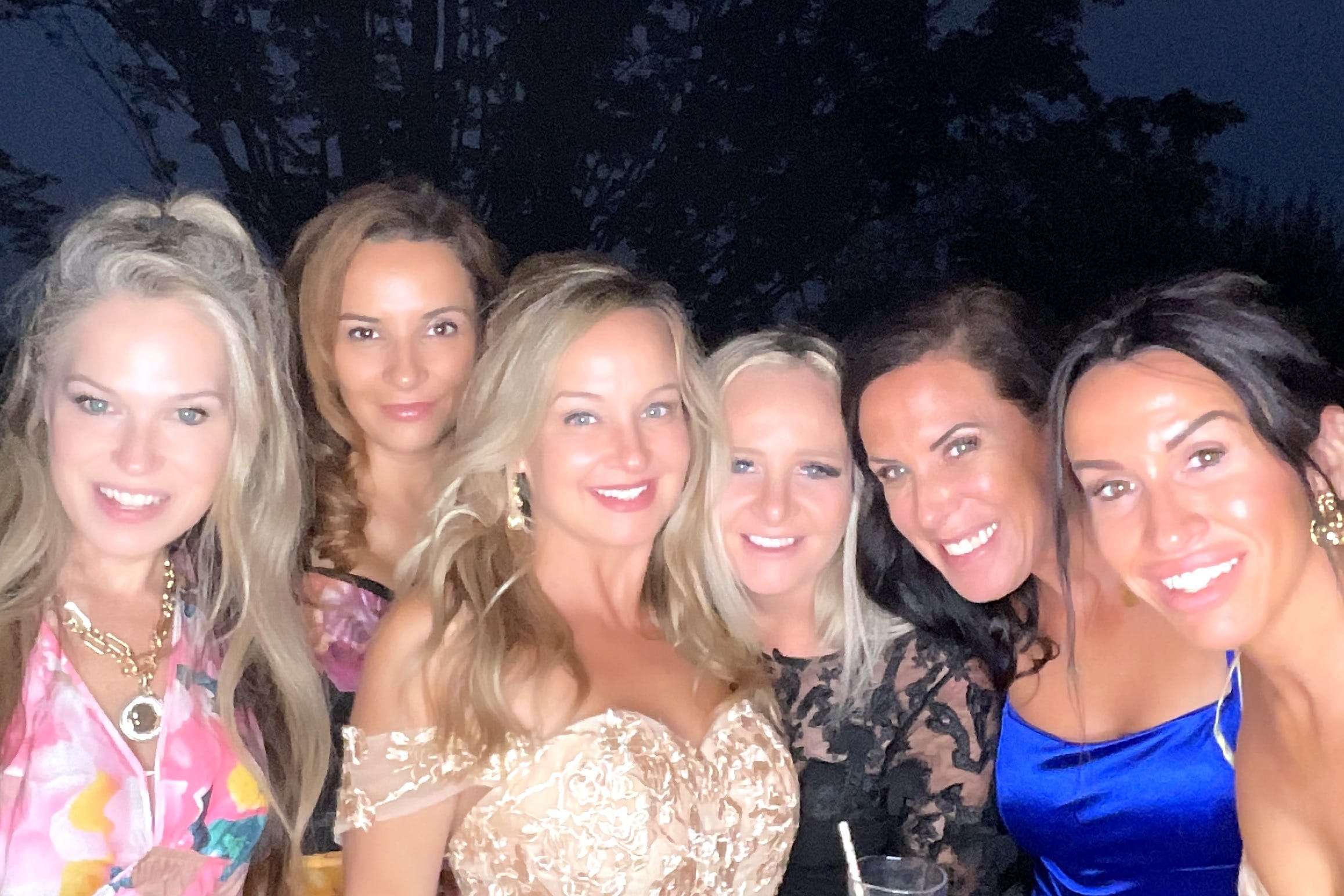 Group of women enjoying a selfie station at an event.