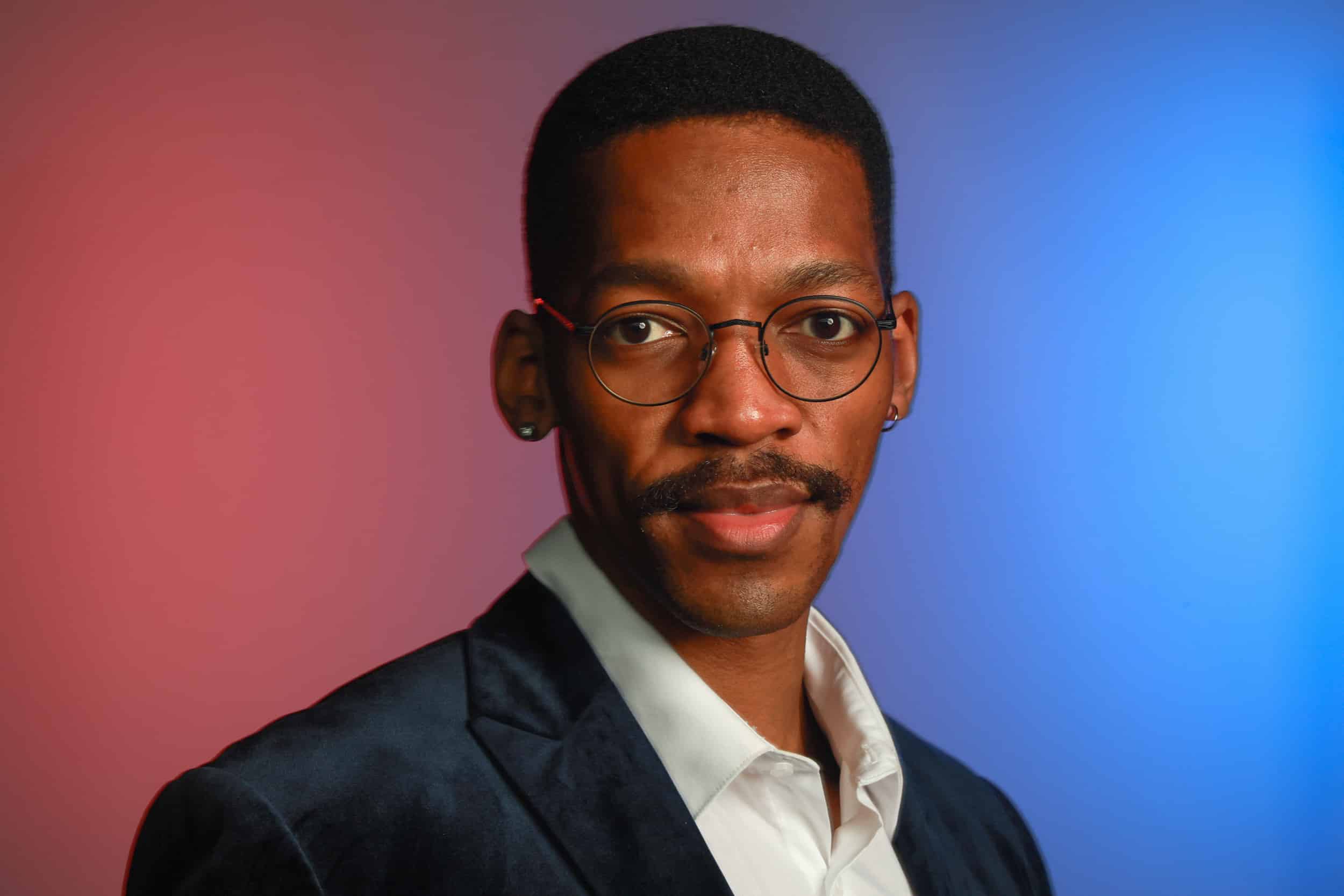 Studio-quality headshot portrait of a man with glasses, showcasing Magic Mirror of New England's Portrait Studio Station.
