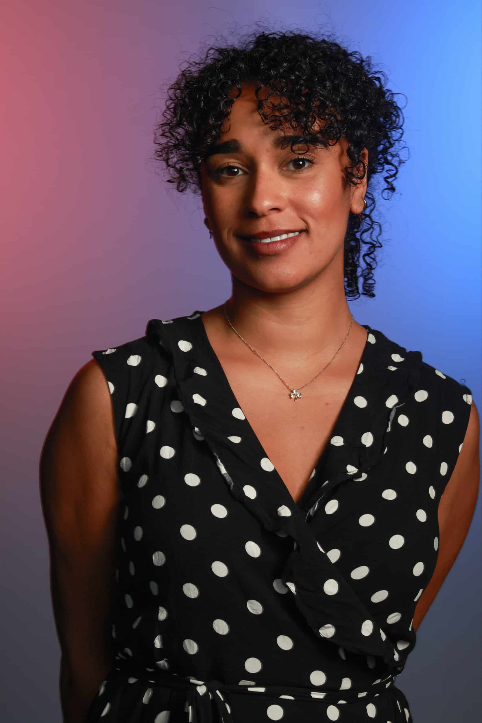 Professional headshot portrait with studio lighting and branded background for corporate and wedding events.