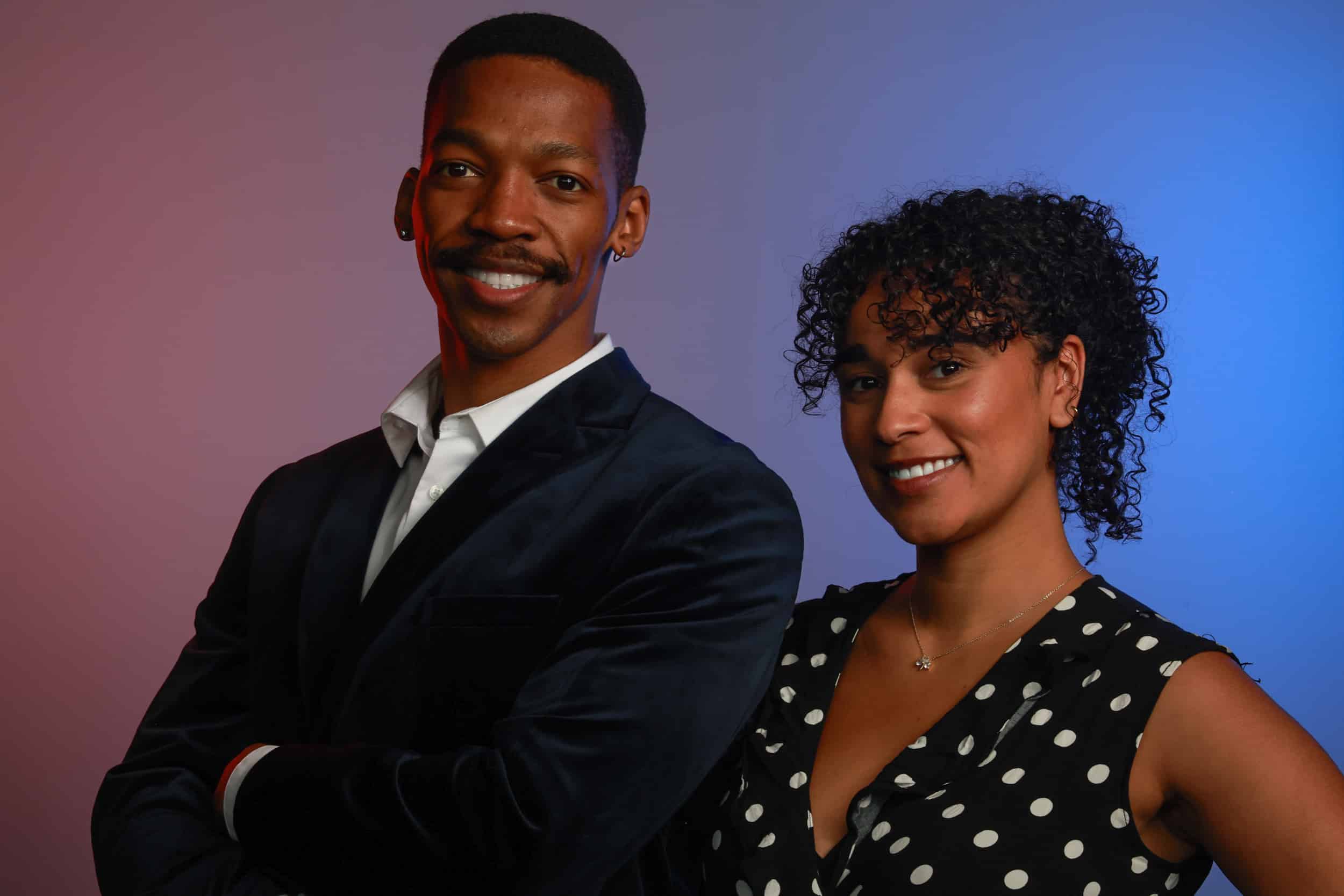 Professional portrait studio image of a smiling couple at a corporate event