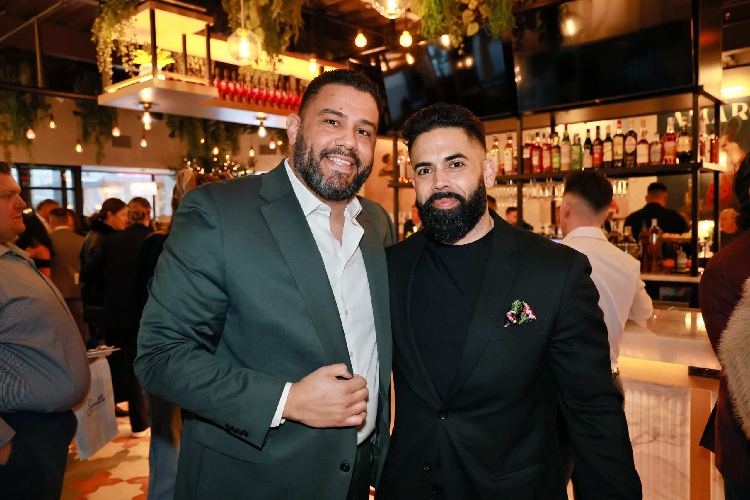Two male guests posing together during a corporate event photographed by Magic Mirror of New England