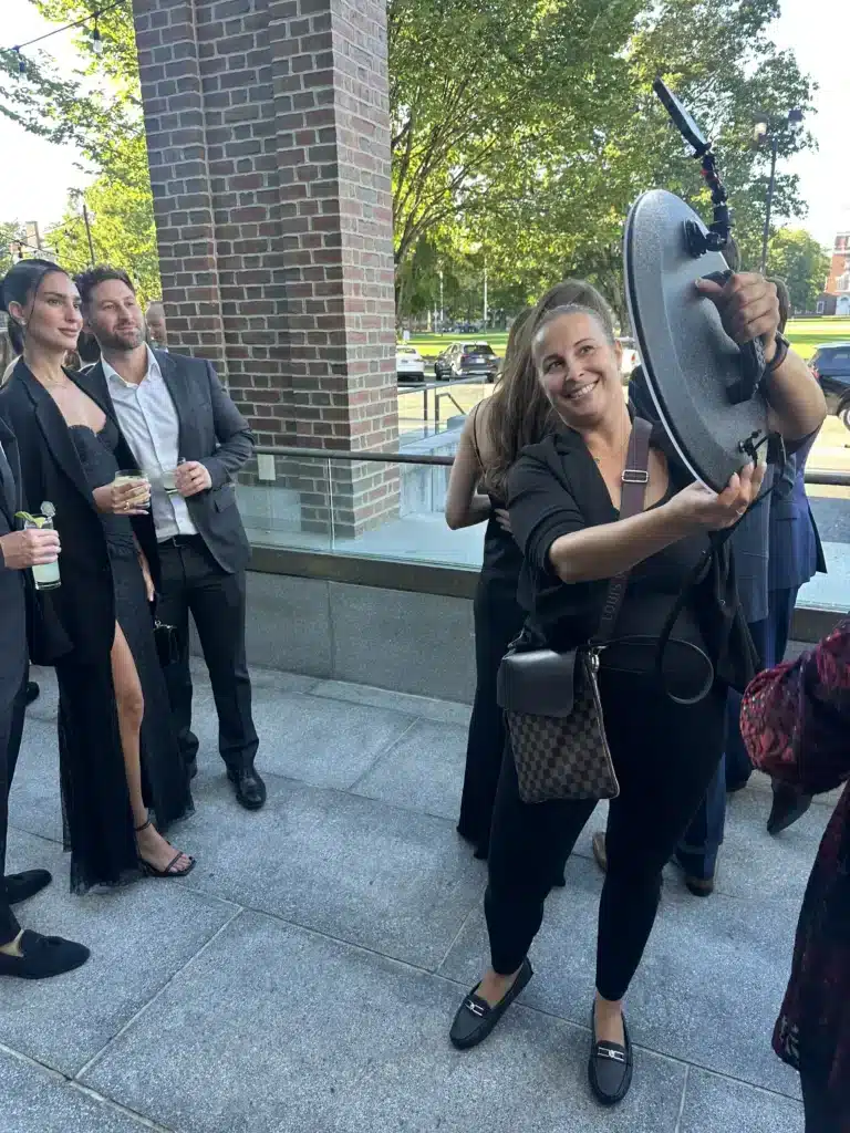 Guests posing for a roaming photographer at an outdoor event venue