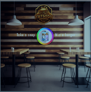 Branded 'Take a snap, win a burger' photo installation on a restaurant dining room wall.
