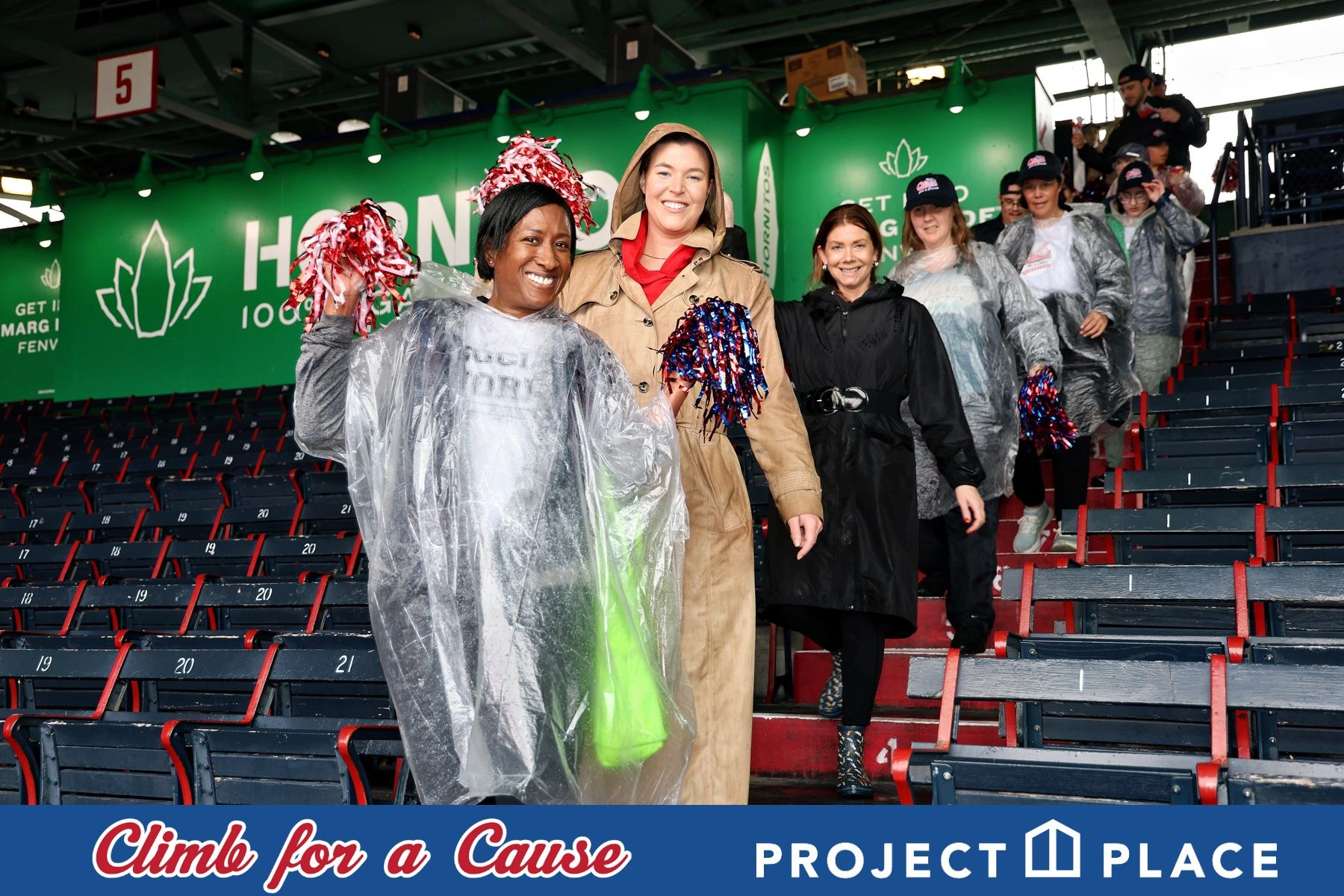 Participant in a poncho climbing stairs at the Climb for a Cause charity event