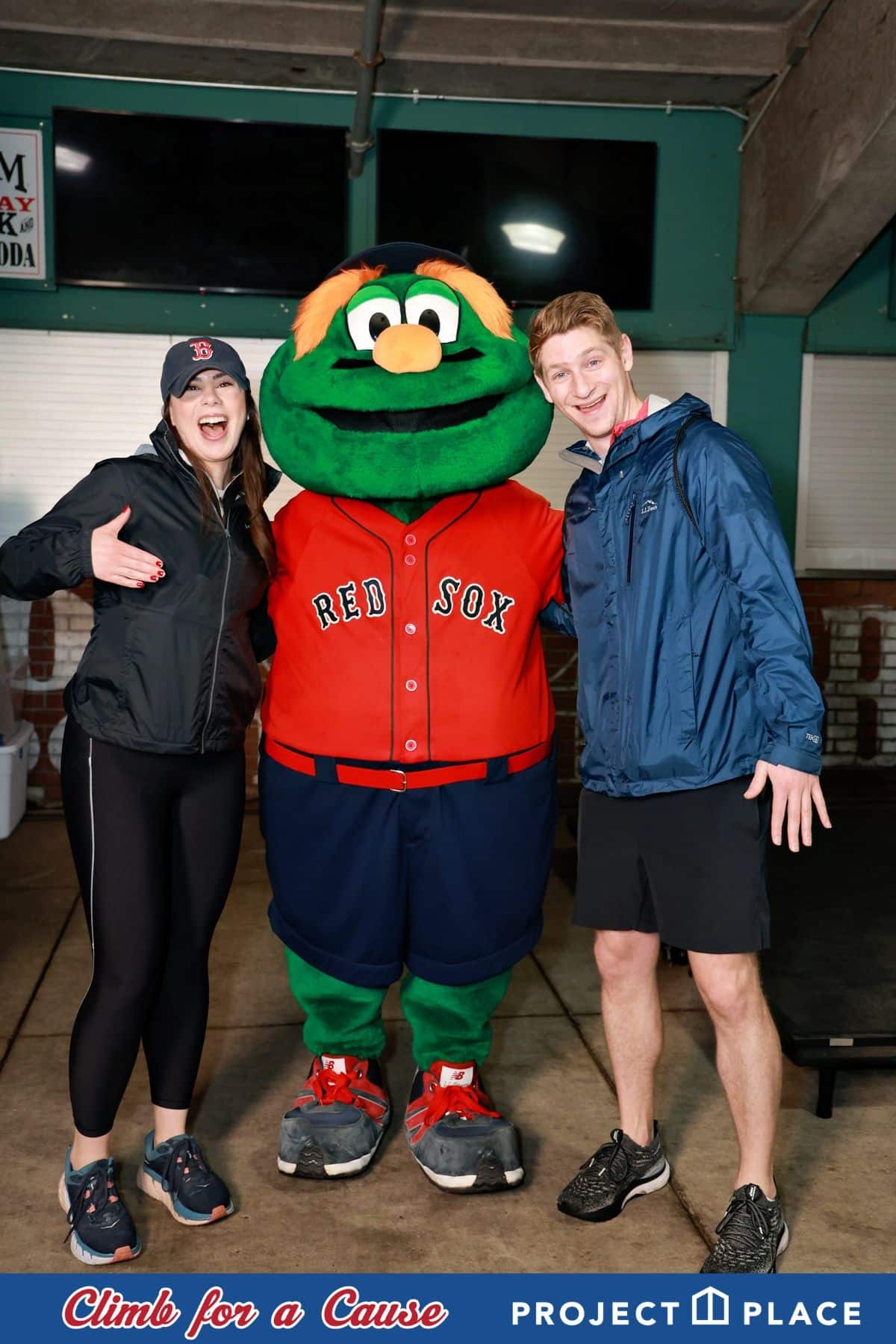 Participants posing with Wally the Green Monster at the Climb for a Cause charity event