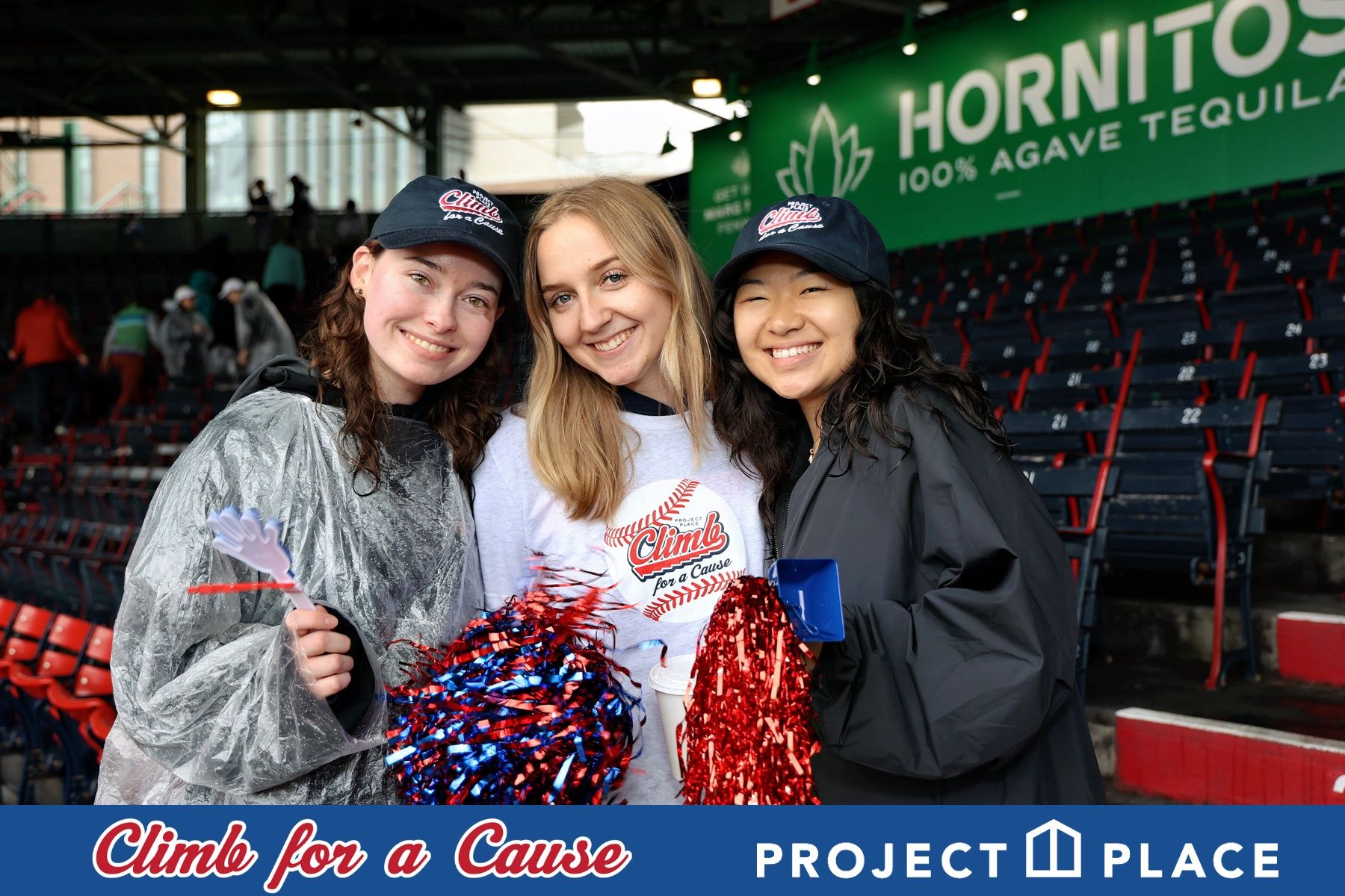 Participants cheering with pom-poms at the Climb for a Cause charity event