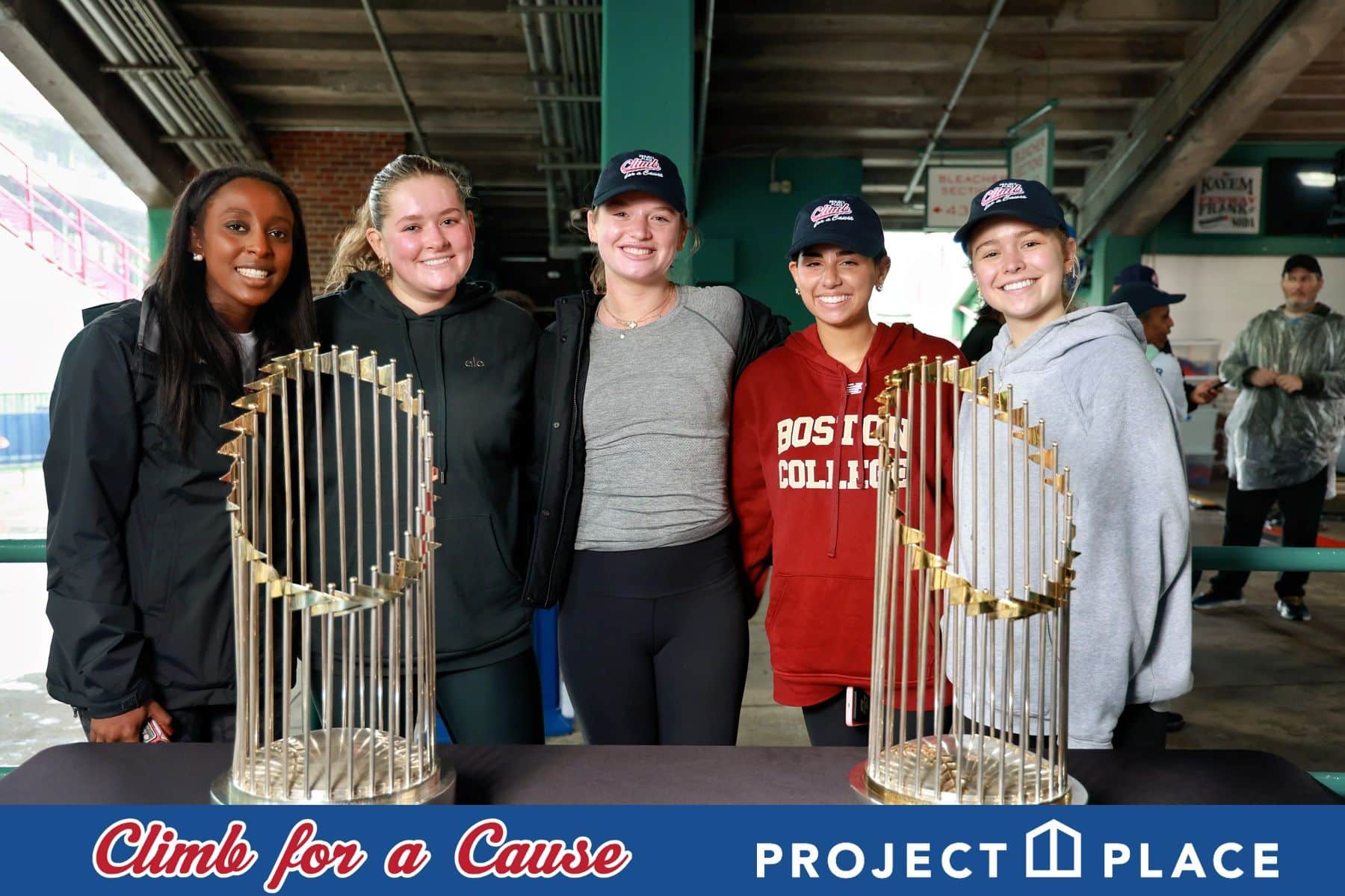 Group of participants posing with championship trophies at the Climb for a Cause charity event