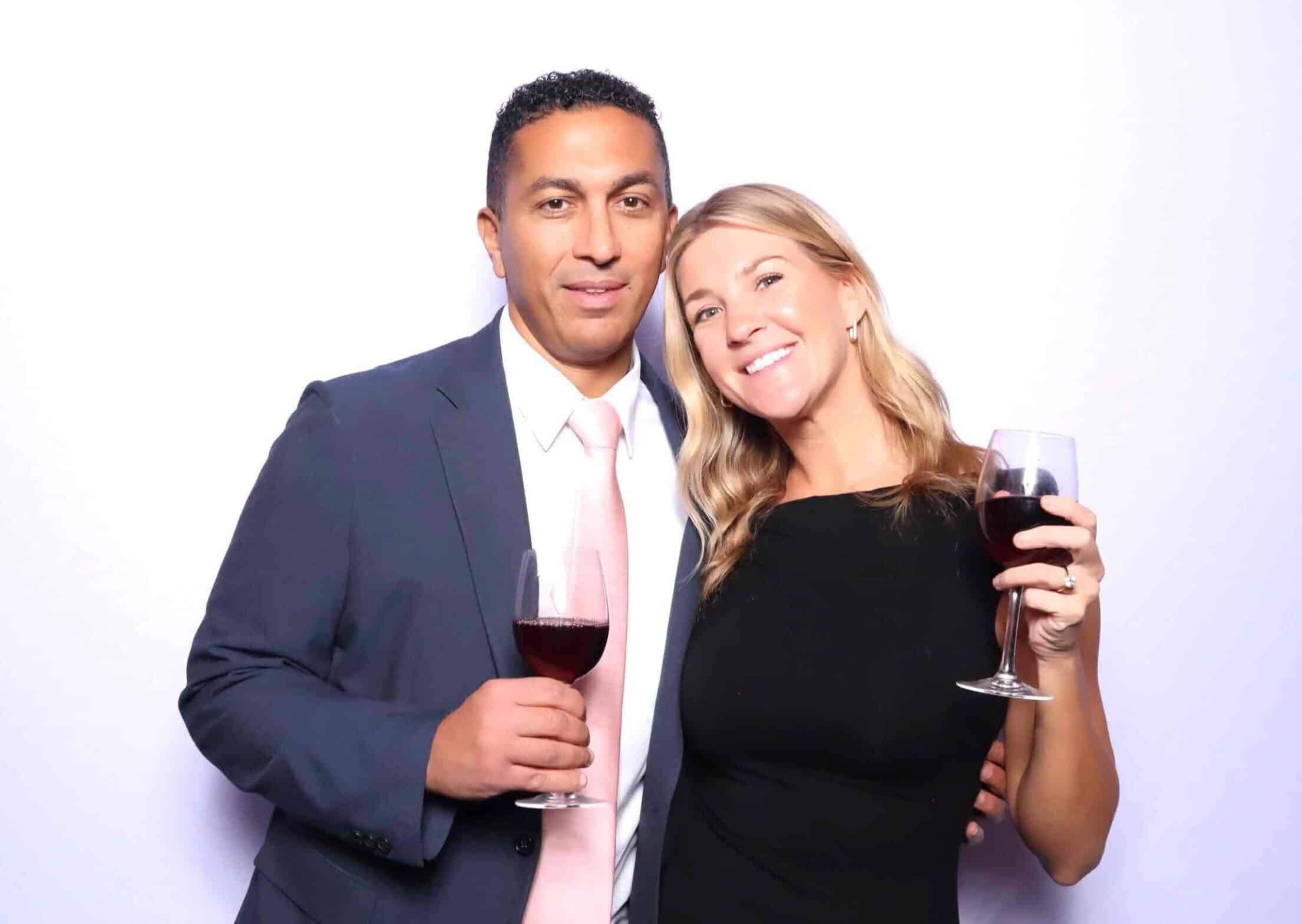 Two guests posing at the GLAM Photo Booth at the Runway for Recovery event