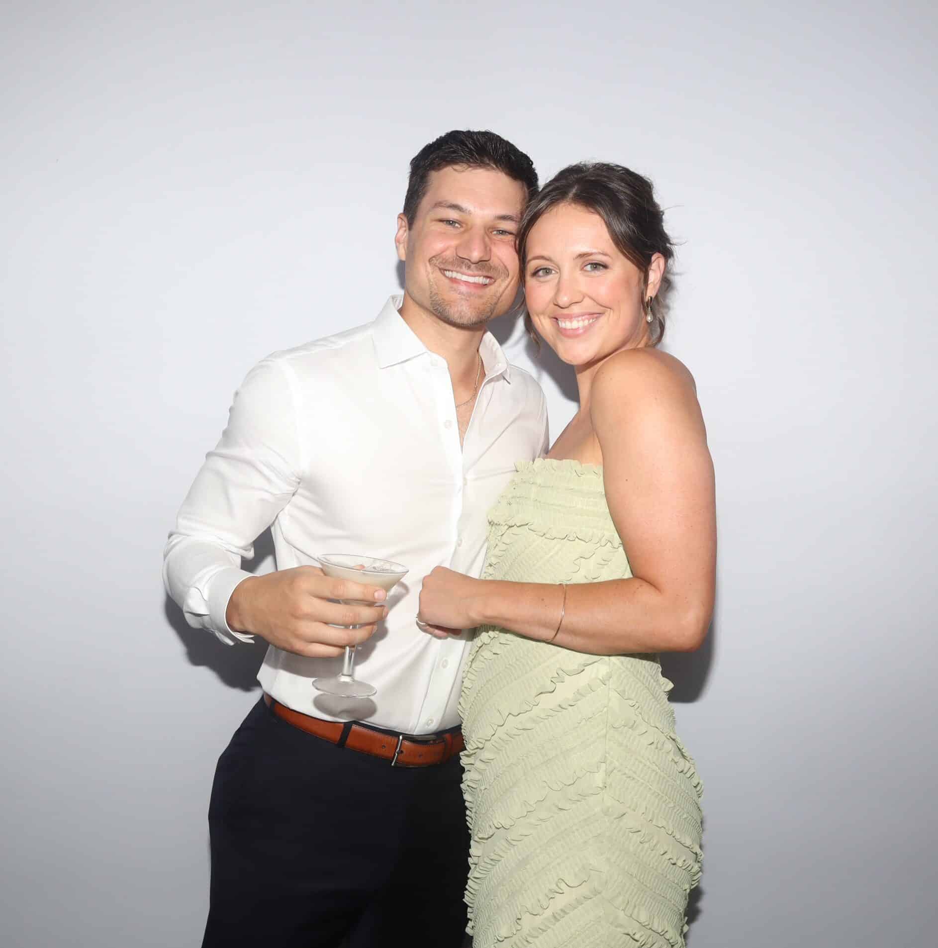Couple smiling together at a Maine wedding photo booth