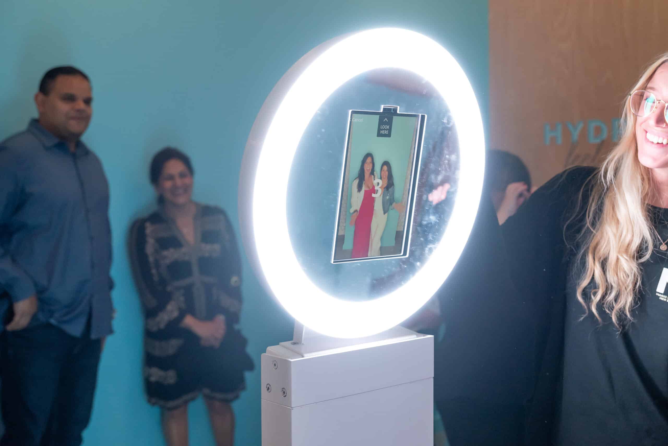Guests posing at the Dream Booth open-air photo booth at a corporate event