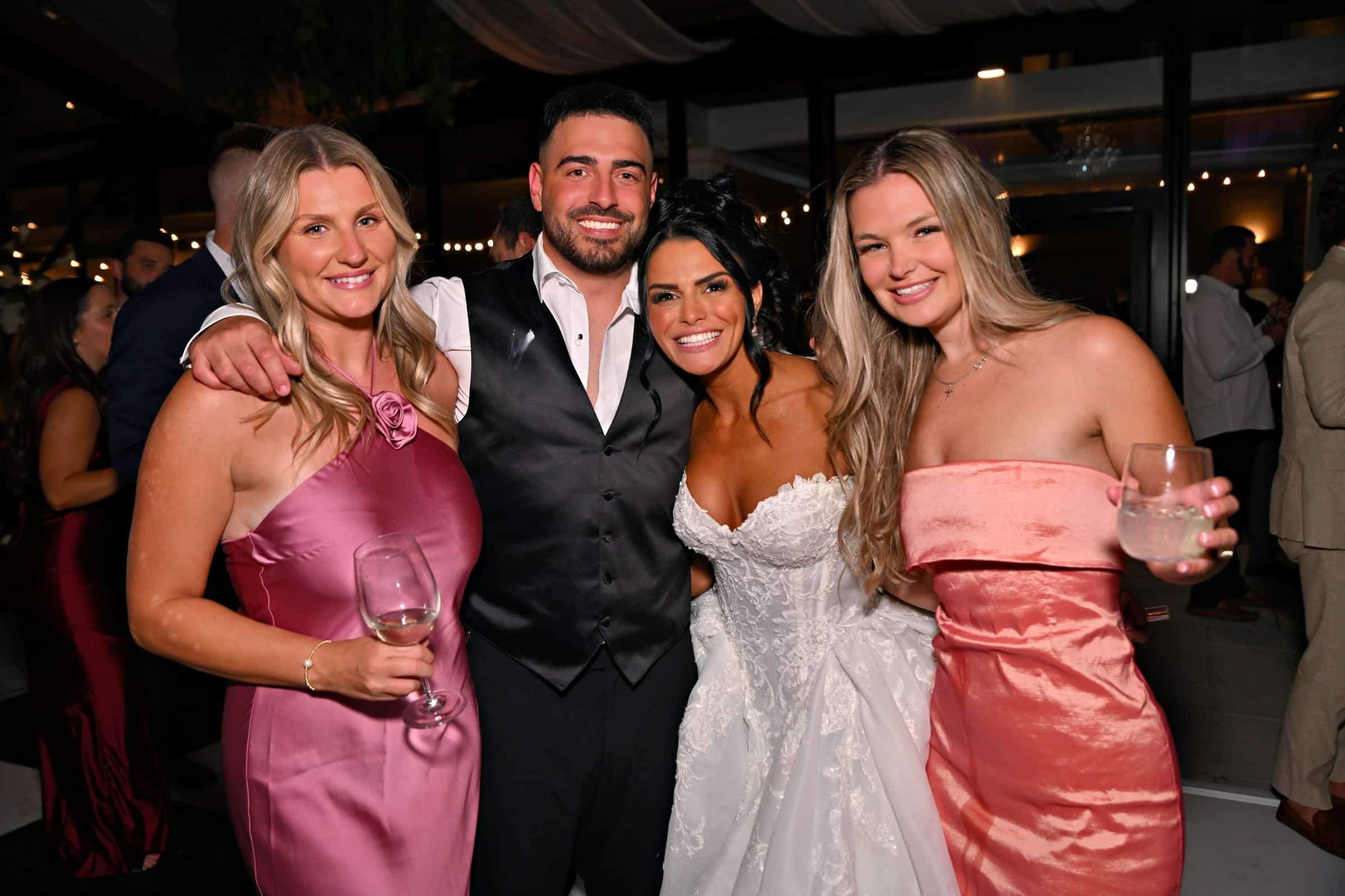 Bride and groom with friends on the dance floor at The Artisan Hotel at Tuscan Village, Salem NH, event photography by Magic Mirror of New England
