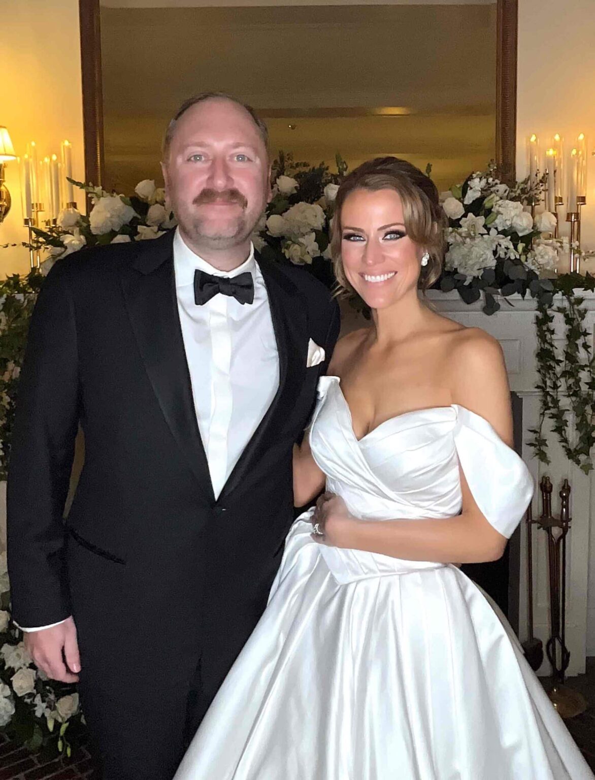 Full color GLAM portrait of a groom in a black tuxedo and a bride in a white satin gown at a Dream Booth wedding