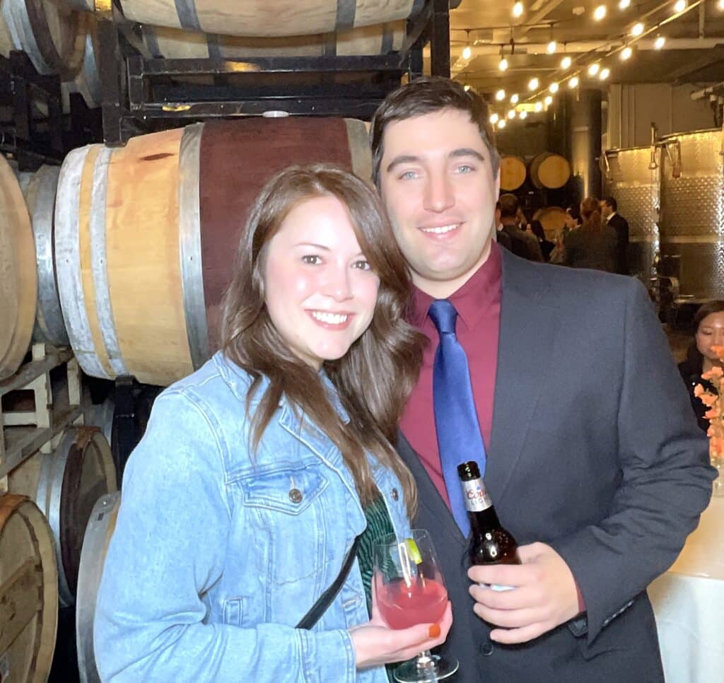 Couple at cocktail hour by the wine barrels, LaBelle Winery Amherst NH roaming photo booth