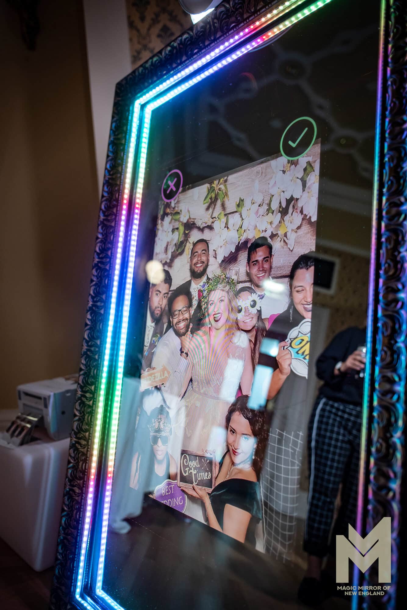 Magic Mirror photo booth with a rainbow LED frame showing a guest photo preview with approve and retake buttons